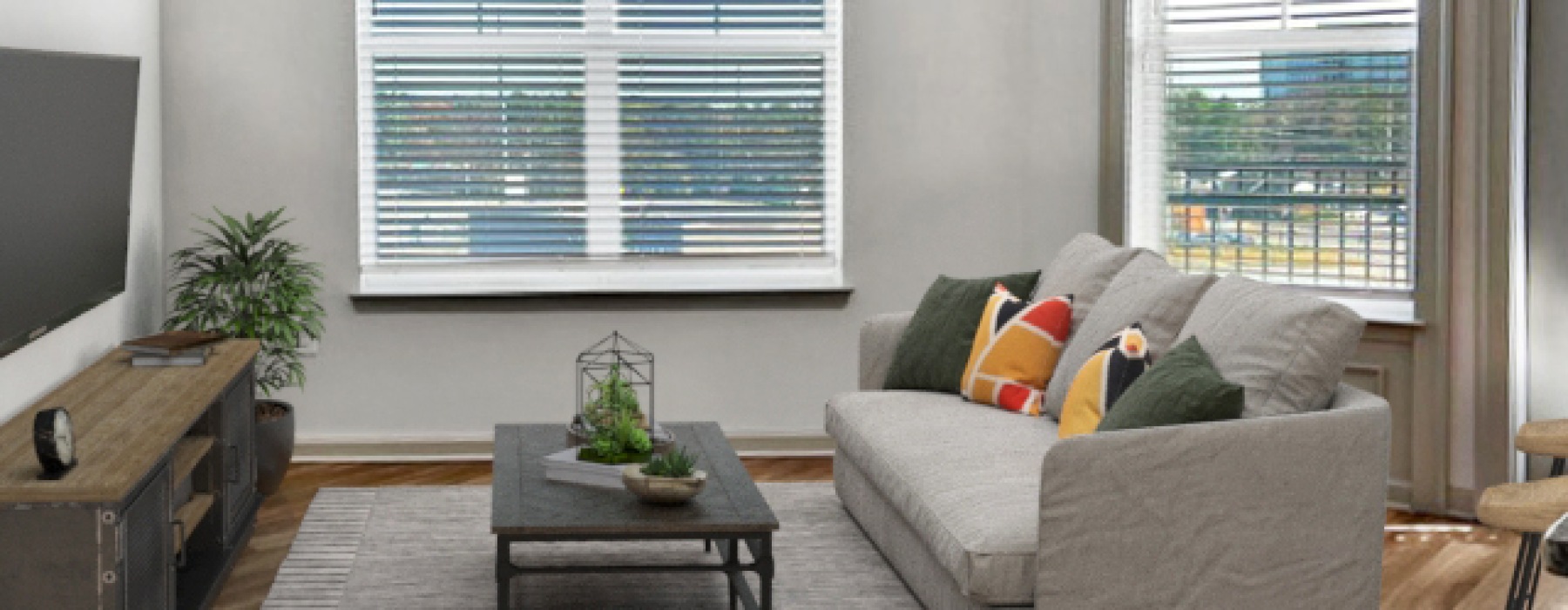 Living room of A4 floor plan with sofa, coffee table, and entertainment center with tv