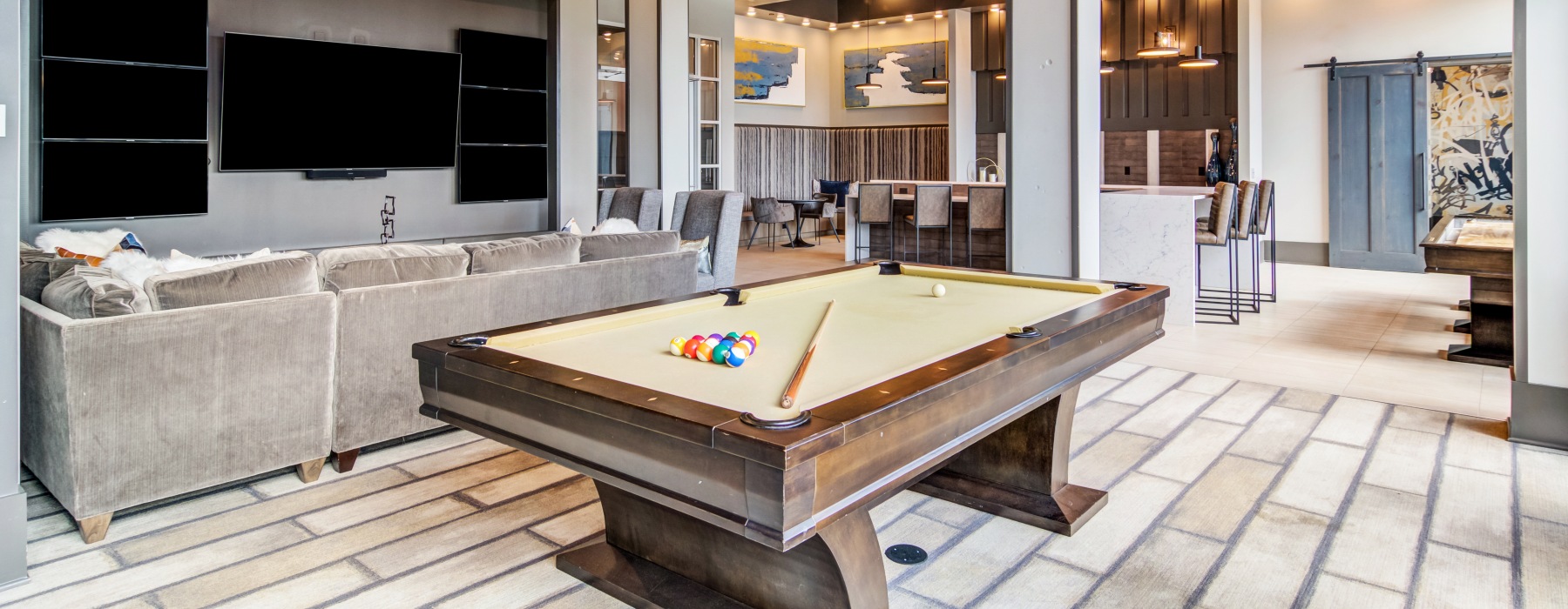 Modern apartment clubhouse with lounge seating, entertainment areas, and resident amenities at Marketplace Village apartments in Marietta, Georgia
