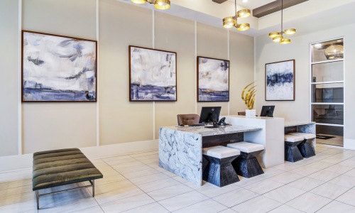 Leasing center with white marble desks and chairs at Marketplace Village